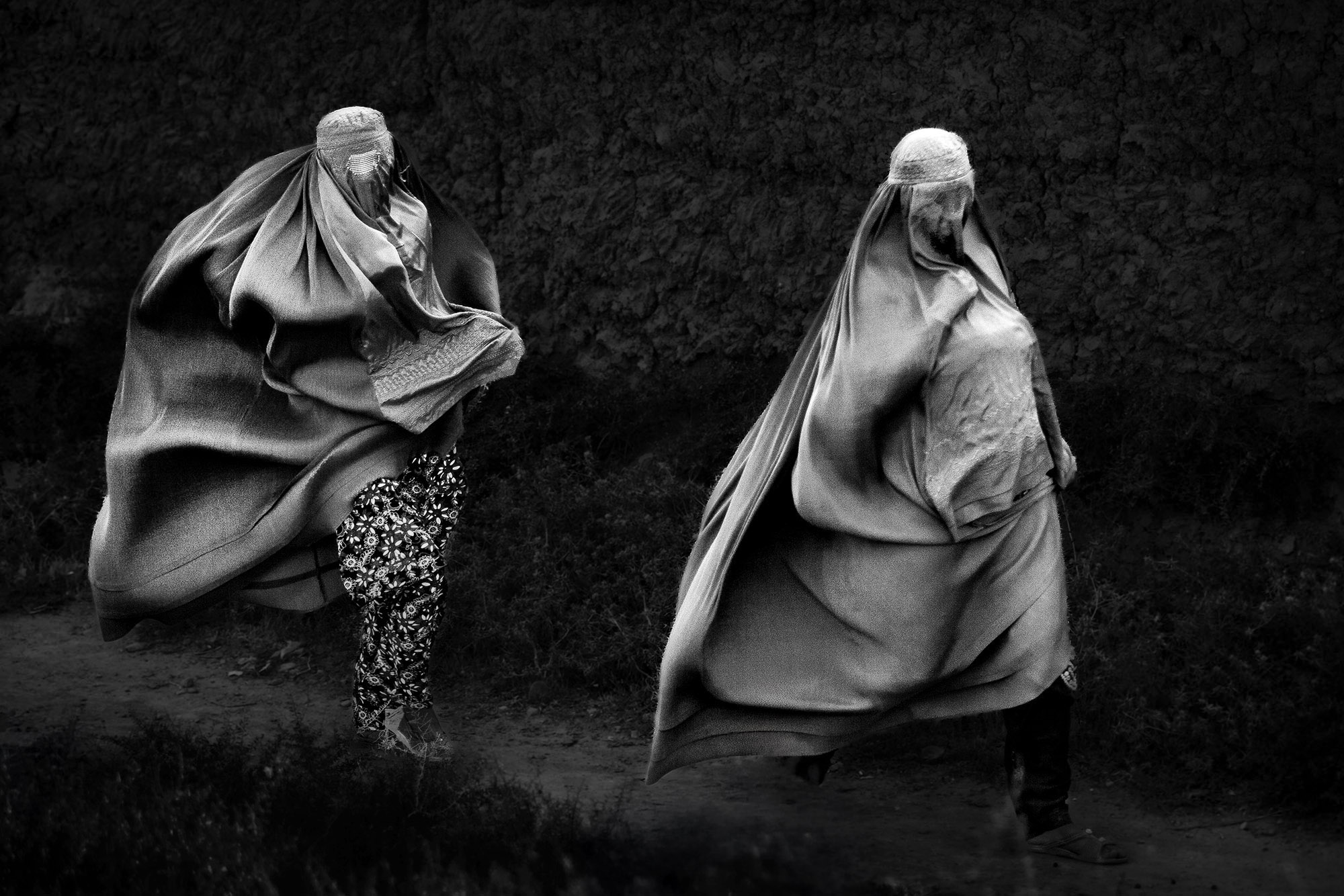 In the wind of Parwan burqa in Afghanistan. Black and white